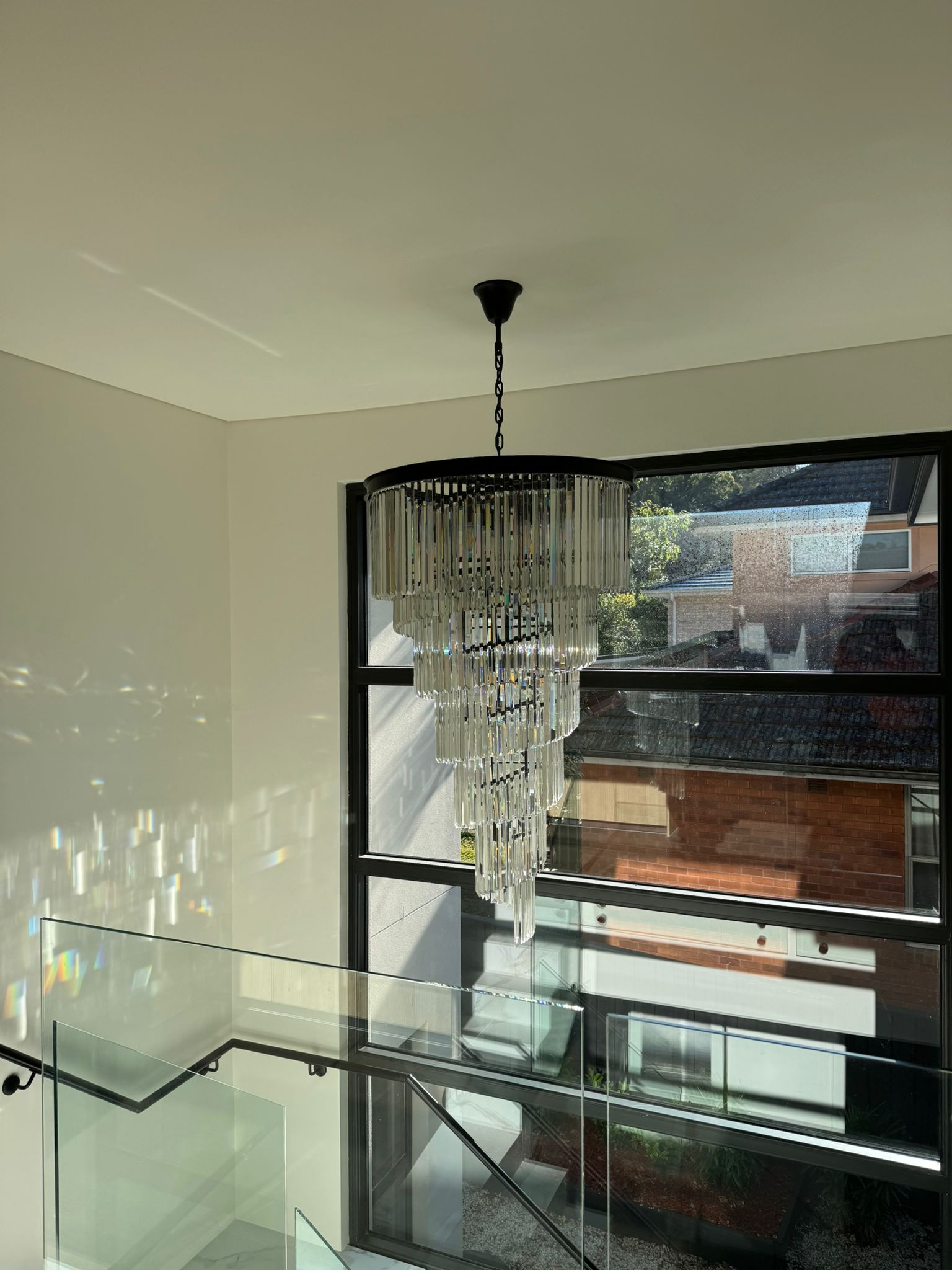 Crystal chandelier installation in new build