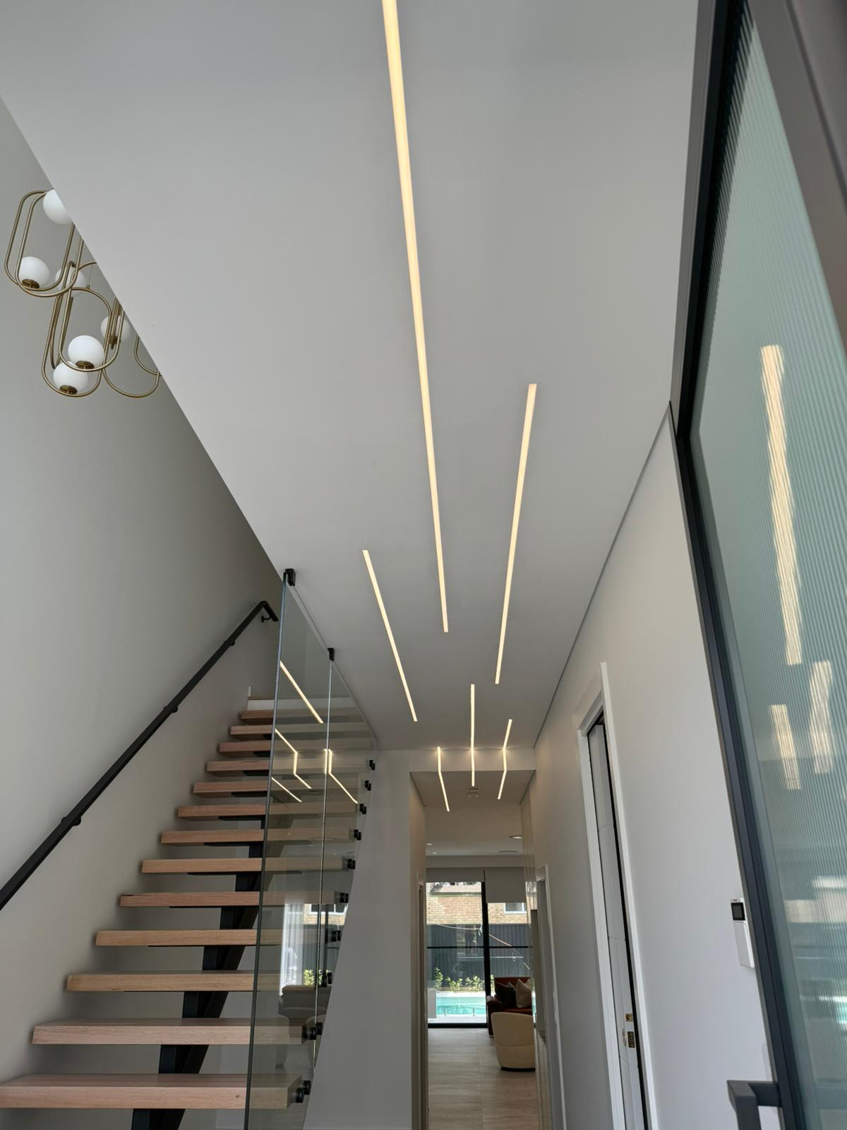 Staircase with LED linear ceiling lighting